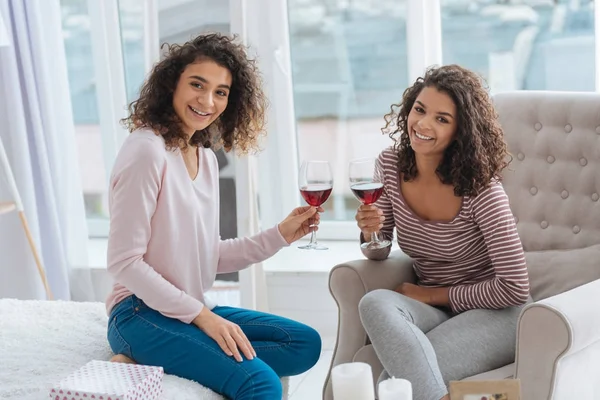Beautiful siblings enjoying red wine together