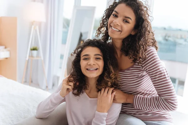 Supportive siblings posing for camera and smiling cheerfully — Stock Photo, Image