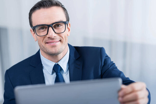 Happy optimistic man taking laptop