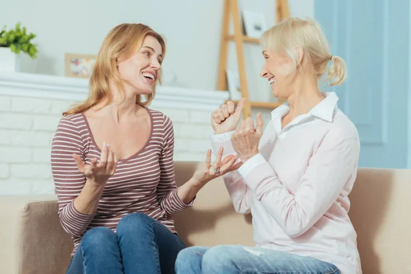 Delighted emotional woman telling wonderful news to a positive grandmother — Stock Photo, Image
