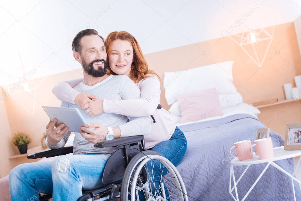 Smiling woman and disabled man relaxing together