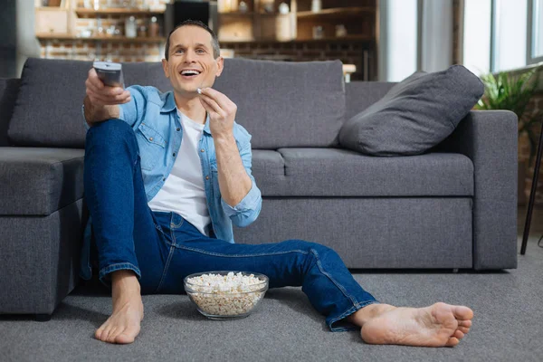 Entspannter Mann isst leckeres Popcorn — Stockfoto