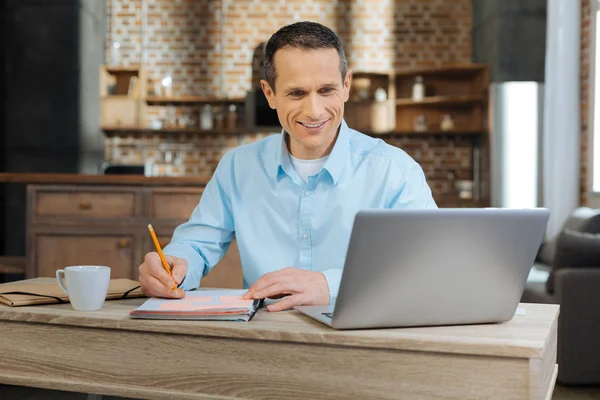 Delighted man looking at screen of his computer — Stock Photo, Image