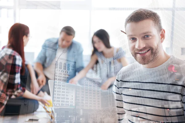 Close up of cheerful man with a pencil behind his ear — Stock Photo, Image