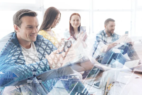 Enthusiastic colleagues using mobile phones in the office — Stock Photo, Image