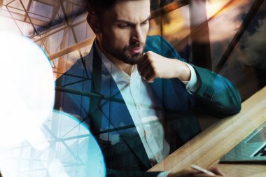 young man sitting at the table  clipart