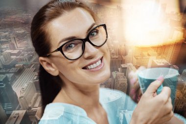 Bir fincan kahve tutan genç kadın