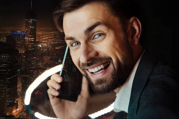 Close up of cheerful man in suit talking on phone — Stock Photo, Image