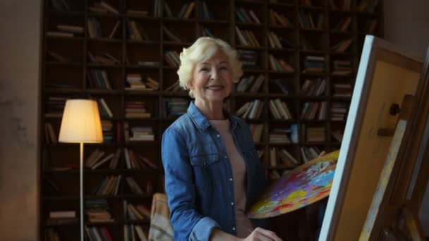 Encantada mulher idosa desfrutando de desenho em casa — Vídeo de Stock