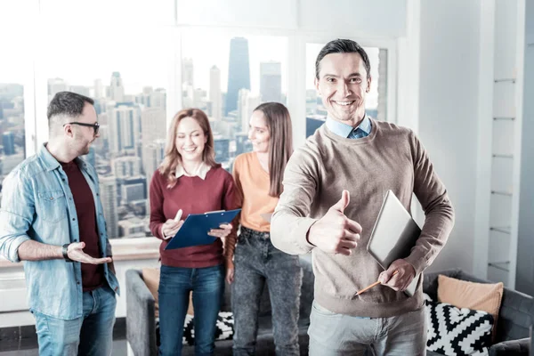 Schöner fröhlicher Mann stehend und gestikulierend. — Stockfoto