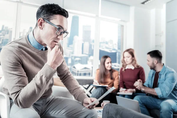 Deep thoughtful man holding and reading the document. — Stock Photo, Image