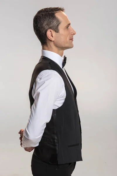 Positive male waiter posing in profile — Stock Photo, Image