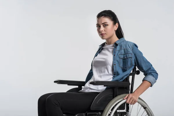 Pensivo aleijado mulher tocando cadeira de rodas — Fotografia de Stock