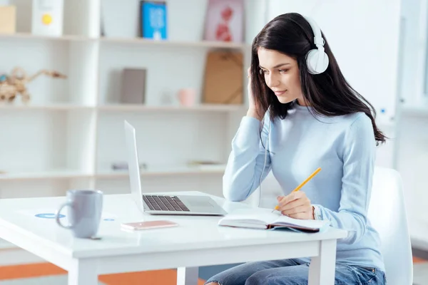 Pleasant female student  listening to music — Stock Photo, Image