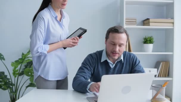 Des collègues joyeux discutent du projet à l'ordinateur portable — Video