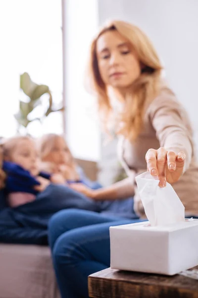 Madre problemática sentada cerca de sus hijos enfermos —  Fotos de Stock