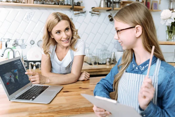 Profile photo of smiling girl that looking at laptop