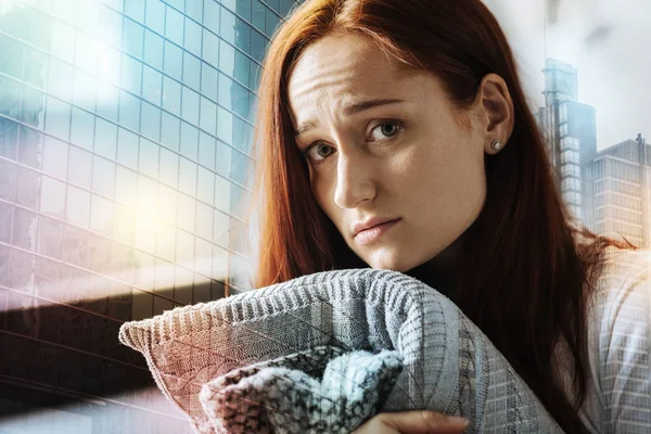 Lonely stressful woman hugging the pillow and looking straight. — Stock Photo, Image