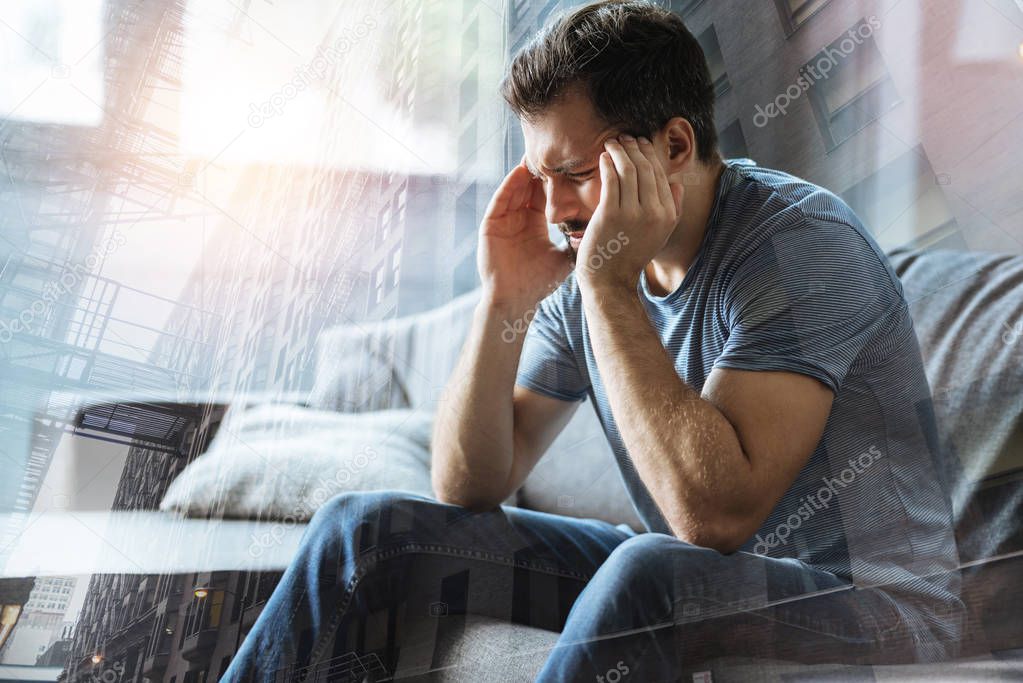 Ill depressed man sitting and feeling dad himself.