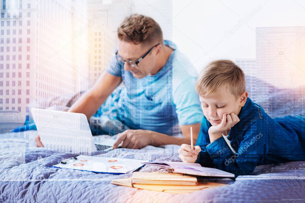 Attentive little male person doing his home work