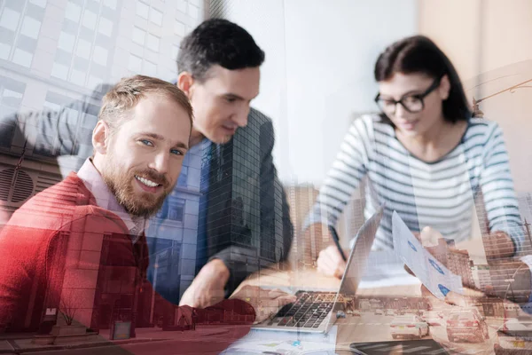 Positive bearded man having a meeting with his colleagues — Stock Photo, Image