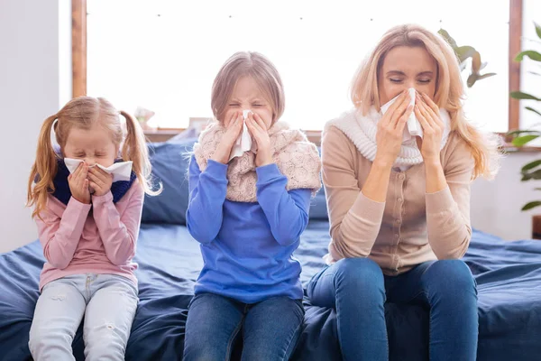 Sick mother and her daughters having a cold — Stock Photo, Image