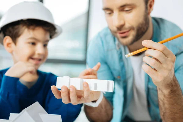 Pleasant father and son scrutinizing 3D house layout — Stock Photo, Image