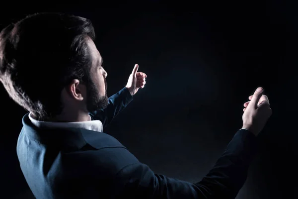 Pleasant handsome businessman holding a virtual object — Stock Photo, Image