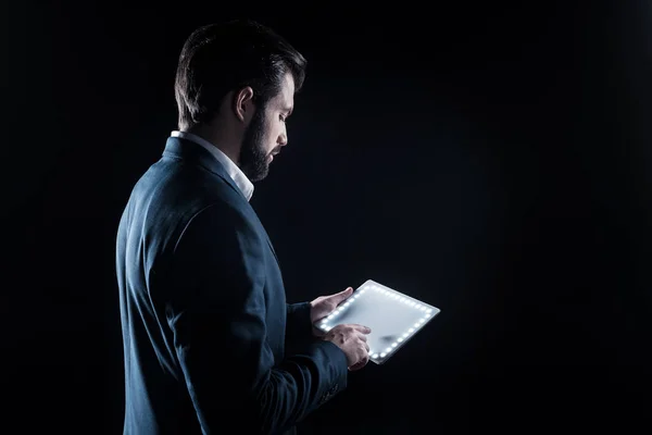 Serious handsome businessman using a tablet — Stock Photo, Image