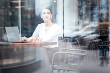 Kafede oturan düşünceli genç kadın