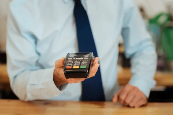 Busy smart man standing and showing the cash machine. — Stock Photo, Image