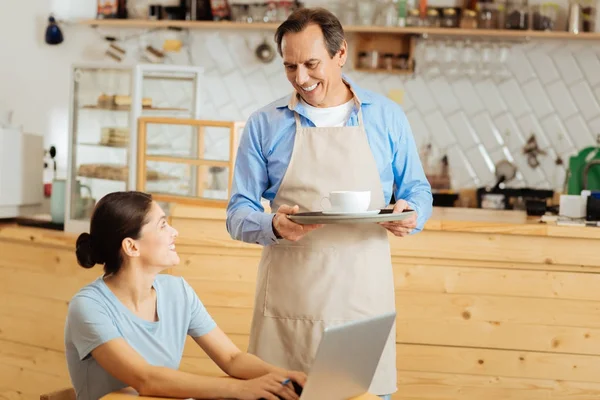 Polite intelligent waiter holding the salver and smiling. — Stock Photo, Image