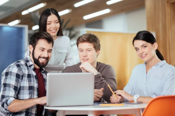 Jolly four colleagues thinking over improvements — Stock Photo, Image