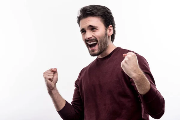 Jubilant man screaming joyfully and clenching fists in triumph — Stock Photo, Image