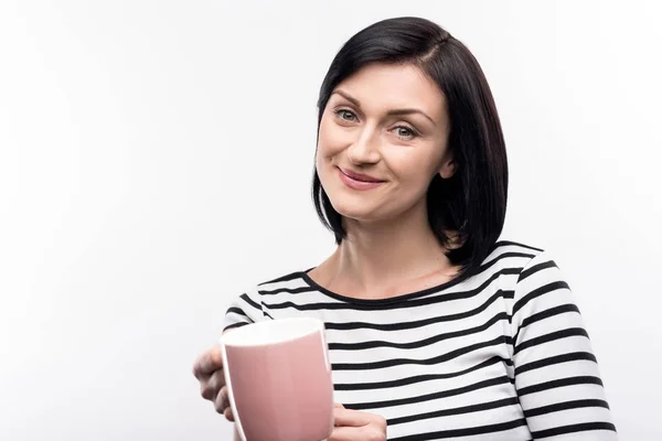 Pleasant woman handing a cup of coffee — Stock Photo, Image