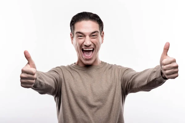 Jubilant middle-aged man showing thumbs up — Stock Photo, Image
