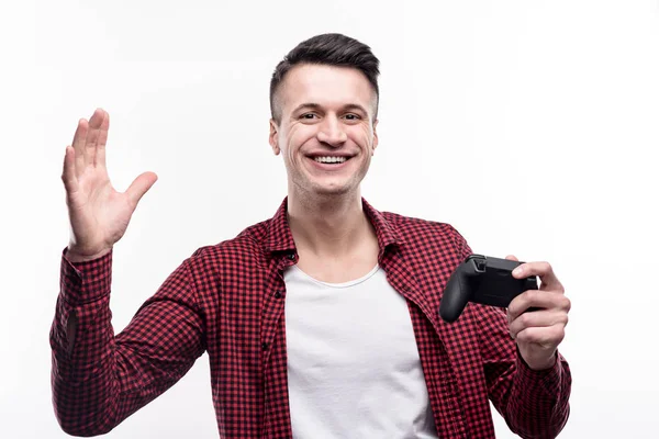 Cheerful man holding game controller and waving — Stock Photo, Image