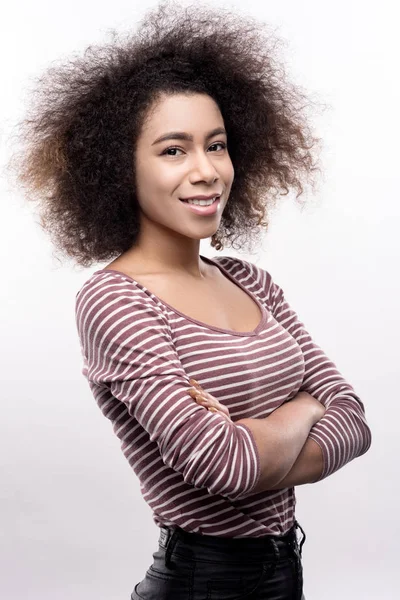 Curly-haired young folding her arms across chest — Stock Photo, Image