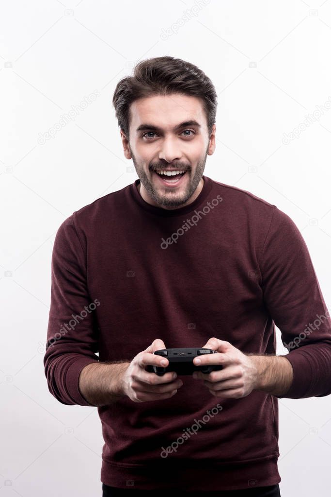 Upbeat man holding a video game controller