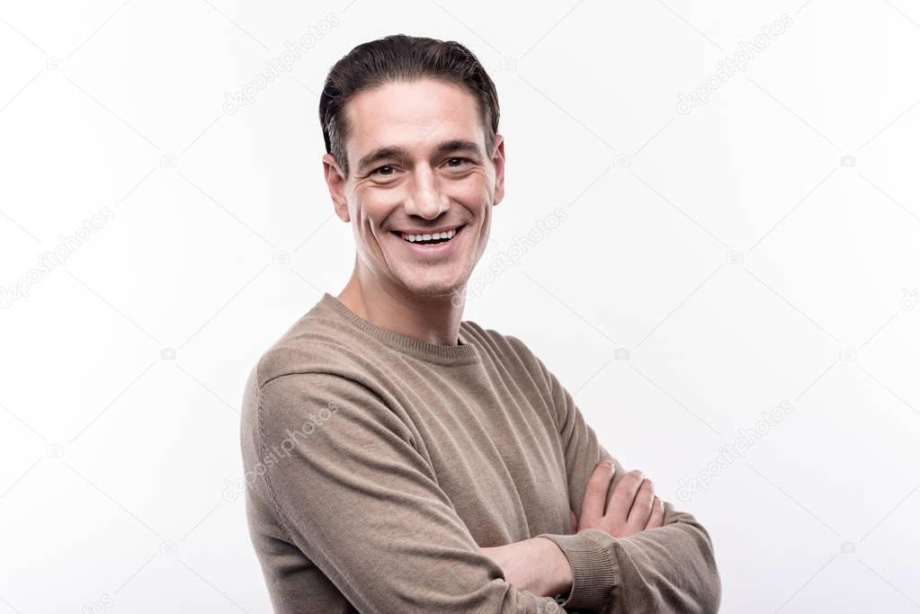 Middle-aged man folding his arms and smiling