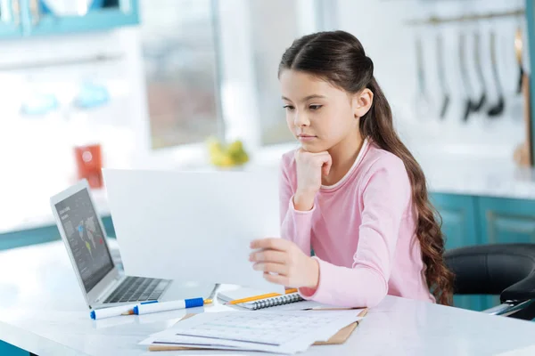 Concentrated girl looking at a sheet of paper — Stock Photo, Image