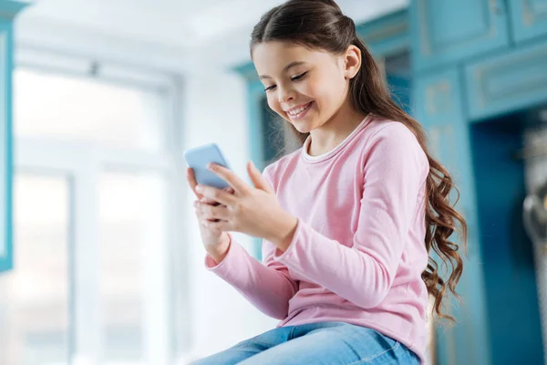 Adorabile sorridente ragazza utilizzando il suo telefono — Foto Stock