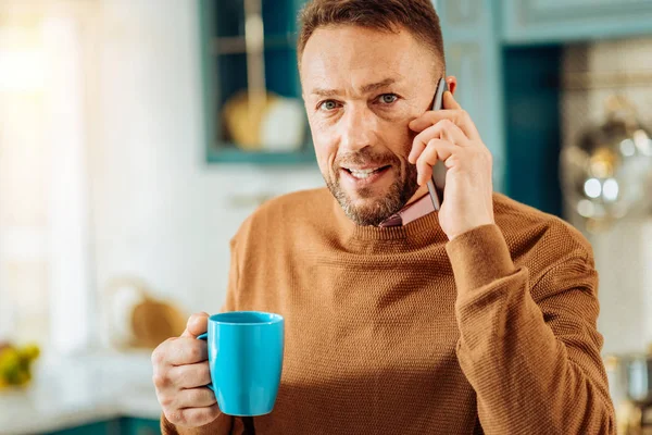 Positive bearded man making a phone call