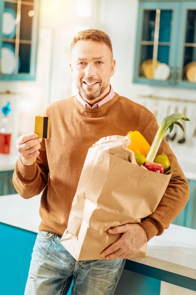 Positive happy man buying food online