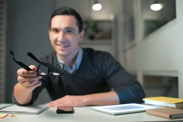 Joven programador masculino estirando gafas — Foto de Stock