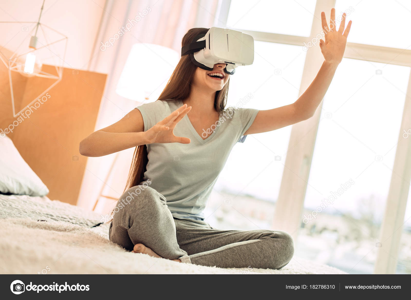 teenage girl playing with VR headset Stock by ©yacobchuk1 182786310