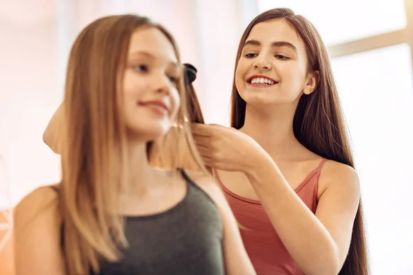 Fröhliches Mädchen bereitet ihre Schwester auf ihr erstes Date vor — Stockfoto