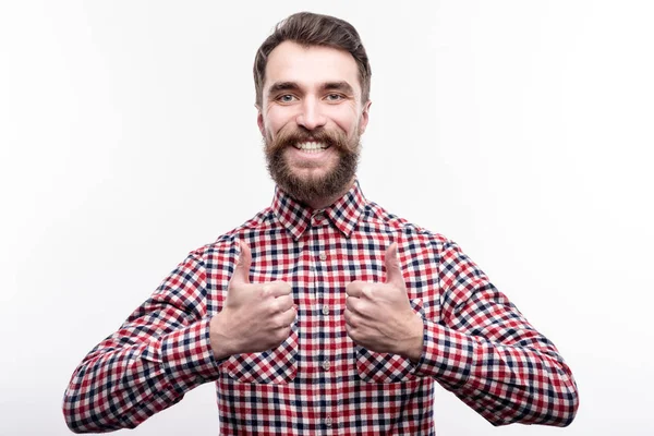 Cheerful man in checked shirt showing thumbs up — Stock Photo, Image