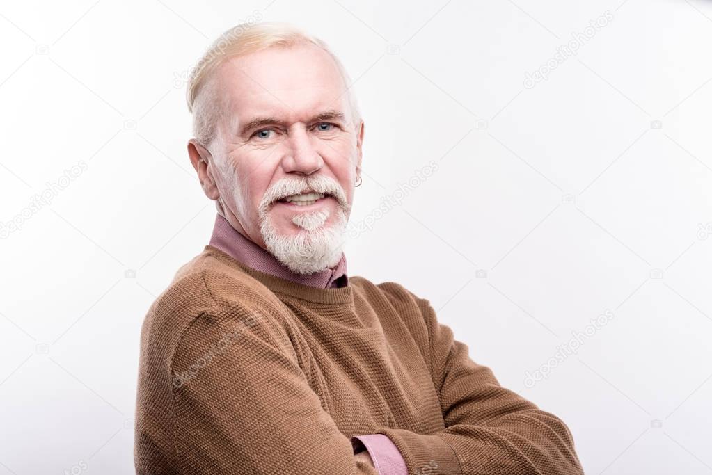 Portrait of pleasant elderly man with grey beard