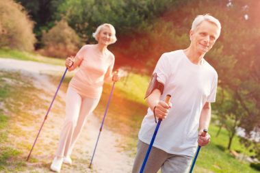 Temiz havada koltuk değneği ile yürüme iyimser yaşlı aile